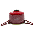 Red MagFeets attached to a small backpacking gas canister